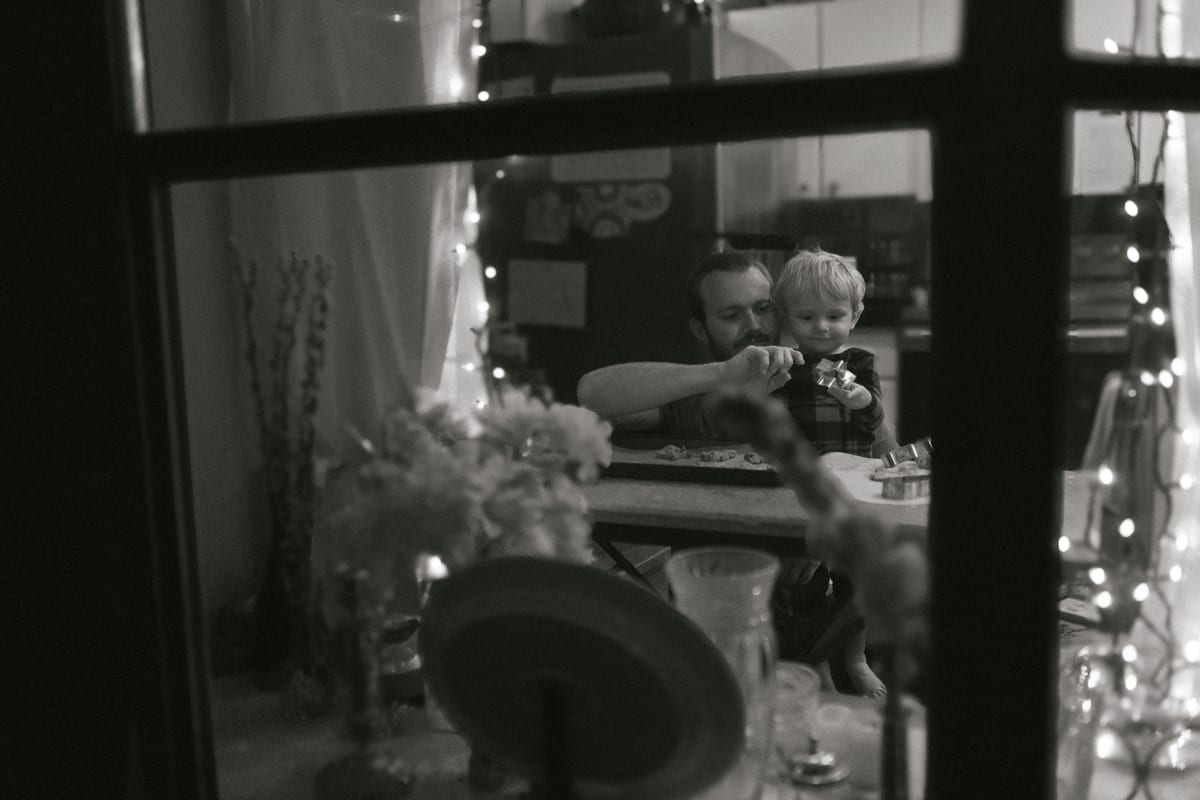 A touching black and white photo of a father and son bonding in a cozy indoor setting.